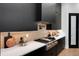 Modern kitchen featuring sleek, black cabinets, stainless steel appliances, quartz countertop, and stylish backsplash at 2645 Delphi Hills Ct, Lakeland, FL 33812