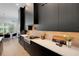 Elegant kitchen with sleek black cabinetry, stainless steel appliances, and a view of the adjacent dining area at 2645 Delphi Hills Ct, Lakeland, FL 33812
