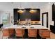 Kitchen featuring a large island with white countertop, black cabinets, and stainless steel appliances at 2645 Delphi Hills Ct, Lakeland, FL 33812