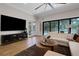Spacious living room with hardwood floors and pool view at 2645 Delphi Hills Ct, Lakeland, FL 33812