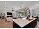 Bright open concept living room flowing from kitchen with a large island, pool view, and modern decor at 2645 Delphi Hills Ct, Lakeland, FL 33812