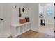 Mudroom featuring a built-in bench with storage, hooks, and a view into the laundry room at 2645 Delphi Hills Ct, Lakeland, FL 33812