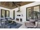 Covered patio with outdoor kitchen featuring stainless steel appliances, bar seating, and dark wood ceilings at 2645 Delphi Hills Ct, Lakeland, FL 33812