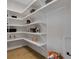 Walk-in pantry offers abundant storage and organization with custom shelving for kitchen essentials at 2645 Delphi Hills Ct, Lakeland, FL 33812
