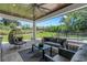 Relaxing covered patio features an outdoor seating area, ceiling fan, and views of backyard at 2645 Delphi Hills Ct, Lakeland, FL 33812