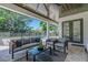 Covered patio with a dark wood ceiling has seating and views of the pool and backyard at 2645 Delphi Hills Ct, Lakeland, FL 33812