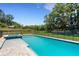 Beautiful pool area with a safety fence, perfect for relaxation and outdoor enjoyment in a serene backyard setting at 2645 Delphi Hills Ct, Lakeland, FL 33812