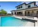 Backyard swimming pool is surrounded by a dark safety fence, and the house is in the background at 2645 Delphi Hills Ct, Lakeland, FL 33812