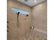 Modern tiled shower with pebble floor, bench, and dual shower heads at 2645 Delphi Hills Ct, Lakeland, FL 33812