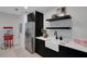 The wet bar features modern cabinetry, stainless steel appliances, and sleek countertops at 2645 Delphi Hills Ct, Lakeland, FL 33812