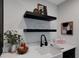 Wet bar with sleek countertops, modern faucet, and open shelving for stylish storage at 2645 Delphi Hills Ct, Lakeland, FL 33812