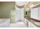 Spacious bathroom featuring double sinks with a marble countertop and vanity with tiled flooring at 2820 Prestwick Dr, Lakeland, FL 33803