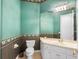 Bathroom with a toilet, sink and a floral wallpaper border at 2820 Prestwick Dr, Lakeland, FL 33803