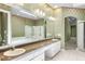 Bathroom featuring a large vanity, dual sinks, tiled flooring, and floral wallpaper border detail at 2820 Prestwick Dr, Lakeland, FL 33803