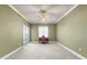 Bedroom featuring neutral carpet, bright windows, ceiling fan and a vintage desk at 2820 Prestwick Dr, Lakeland, FL 33803
