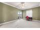 Bedroom with neutral carpet, windows, and glass doors at 2820 Prestwick Dr, Lakeland, FL 33803