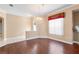 The dining area has hardwood floors, a chandelier, a window with coverings, and chair rail molding at 2820 Prestwick Dr, Lakeland, FL 33803