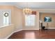 Bright dining room featuring wood floors, a chandelier, and large windows for plenty of natural light at 2820 Prestwick Dr, Lakeland, FL 33803