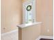 Interior entryway featuring a half-wall, neutral paint, and tile flooring with natural light from the front door at 2820 Prestwick Dr, Lakeland, FL 33803