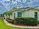 Charming exterior featuring lush landscaping, palm trees, and well-maintained walkway at 2820 Prestwick Dr, Lakeland, FL 33803