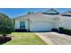 Charming single-story home with a well-maintained lawn and a two-car garage at 2820 Prestwick Dr, Lakeland, FL 33803