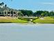 Picturesque view of the community golf course and clubhouse from across the lake at 2820 Prestwick Dr, Lakeland, FL 33803