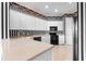 Bright kitchen featuring white cabinets, tiled flooring, and sleek black appliances at 2820 Prestwick Dr, Lakeland, FL 33803