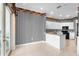 Kitchen featuring breakfast bar, white cabinets, black appliances, and sliding glass doors at 2820 Prestwick Dr, Lakeland, FL 33803