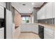 Well-lit kitchen featuring a tiled floor, black appliances, and white cabinetry at 2820 Prestwick Dr, Lakeland, FL 33803