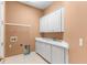 Laundry room featuring a sink, cabinets, and hookups for a washer and dryer at 2820 Prestwick Dr, Lakeland, FL 33803