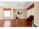 Living room featuring hardwood floors, ceiling fan, tv and an armchair at 2820 Prestwick Dr, Lakeland, FL 33803