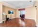 Spacious living room with wood flooring, a ceiling fan, and sliding glass doors leading to the outdoors at 2820 Prestwick Dr, Lakeland, FL 33803
