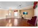 Living room with chandelier, ceiling fan, tv and a sitting chair at 2820 Prestwick Dr, Lakeland, FL 33803