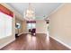 This spacious living room features hardwood floors, neutral paint, natural light, and a large chandelier at 2820 Prestwick Dr, Lakeland, FL 33803