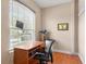 Office featuring a window, desk, chair, hardwood flooring and a picture frame at 2820 Prestwick Dr, Lakeland, FL 33803