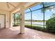 View of the serene lake and golf course from the screened lanai, perfect for relaxation and enjoying the outdoors at 2820 Prestwick Dr, Lakeland, FL 33803