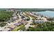 Community aerial view showcasing homes, a clubhouse, and a scenic lake in the background at 3187 Bellflower Way, Lakeland, FL 33811