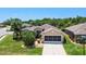 Aerial view of a property with a well-maintained lawn and landscaping and a screened garage at 3187 Bellflower Way, Lakeland, FL 33811