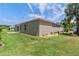 Spacious backyard featuring lush green grass and a screened patio area at 3187 Bellflower Way, Lakeland, FL 33811