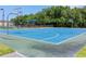 Bright blue basketball court with hoops, ideal for sports and active community engagement at 3187 Bellflower Way, Lakeland, FL 33811