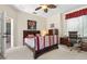 Bedroom with carpeted floors featuring desk, chair and bed at 3187 Bellflower Way, Lakeland, FL 33811
