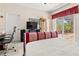 Bright bedroom with large windows, desk, and access to a brick-paved patio at 3187 Bellflower Way, Lakeland, FL 33811