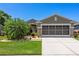 Charming single-story home with a well-manicured lawn and screened two-car garage at 3187 Bellflower Way, Lakeland, FL 33811