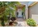 Inviting front entrance with lush greenery, decorative plants and hanging decorative outdoor lighting at 3187 Bellflower Way, Lakeland, FL 33811