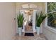 Home's entry way, showcasing plants, brick floors, and a view of the back porch at 3187 Bellflower Way, Lakeland, FL 33811