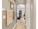 Hallway featuring wood-look tile flooring, towel racks, and an archway entrance to the bedroom at 3187 Bellflower Way, Lakeland, FL 33811