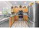 Well-lit kitchen boasts stainless steel appliances, granite counters, and ample storage at 3187 Bellflower Way, Lakeland, FL 33811