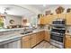 Modern kitchen features stainless appliances, granite countertops, and ample cabinet space at 3187 Bellflower Way, Lakeland, FL 33811