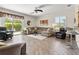 Bright living room featuring sliding doors, wood-look tile, and comfortable seating at 3187 Bellflower Way, Lakeland, FL 33811