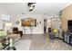 Spacious living area showcasing wood-look tile, neutral decor, and open access to the kitchen at 3187 Bellflower Way, Lakeland, FL 33811